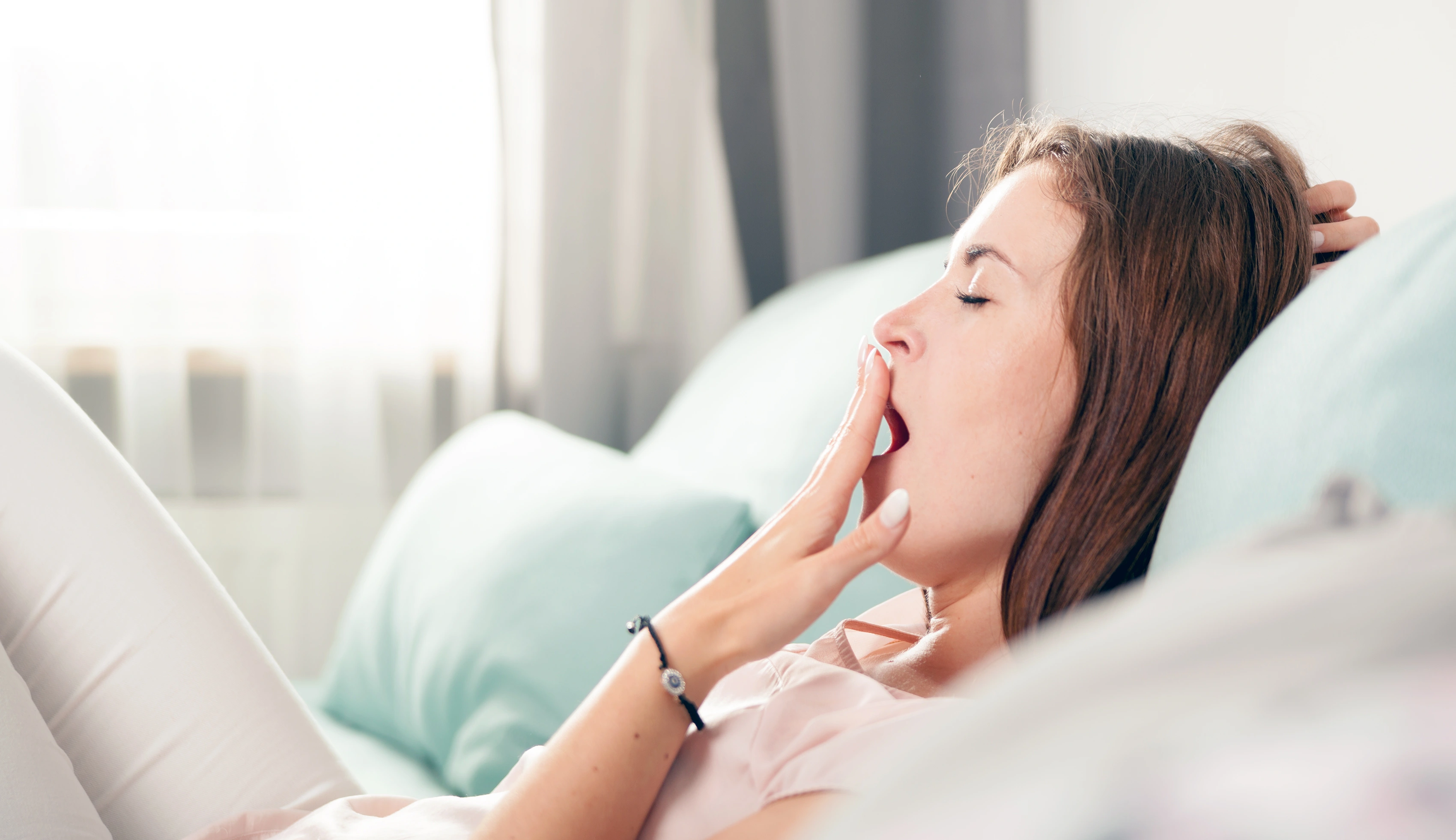 Woman yawning on the couch