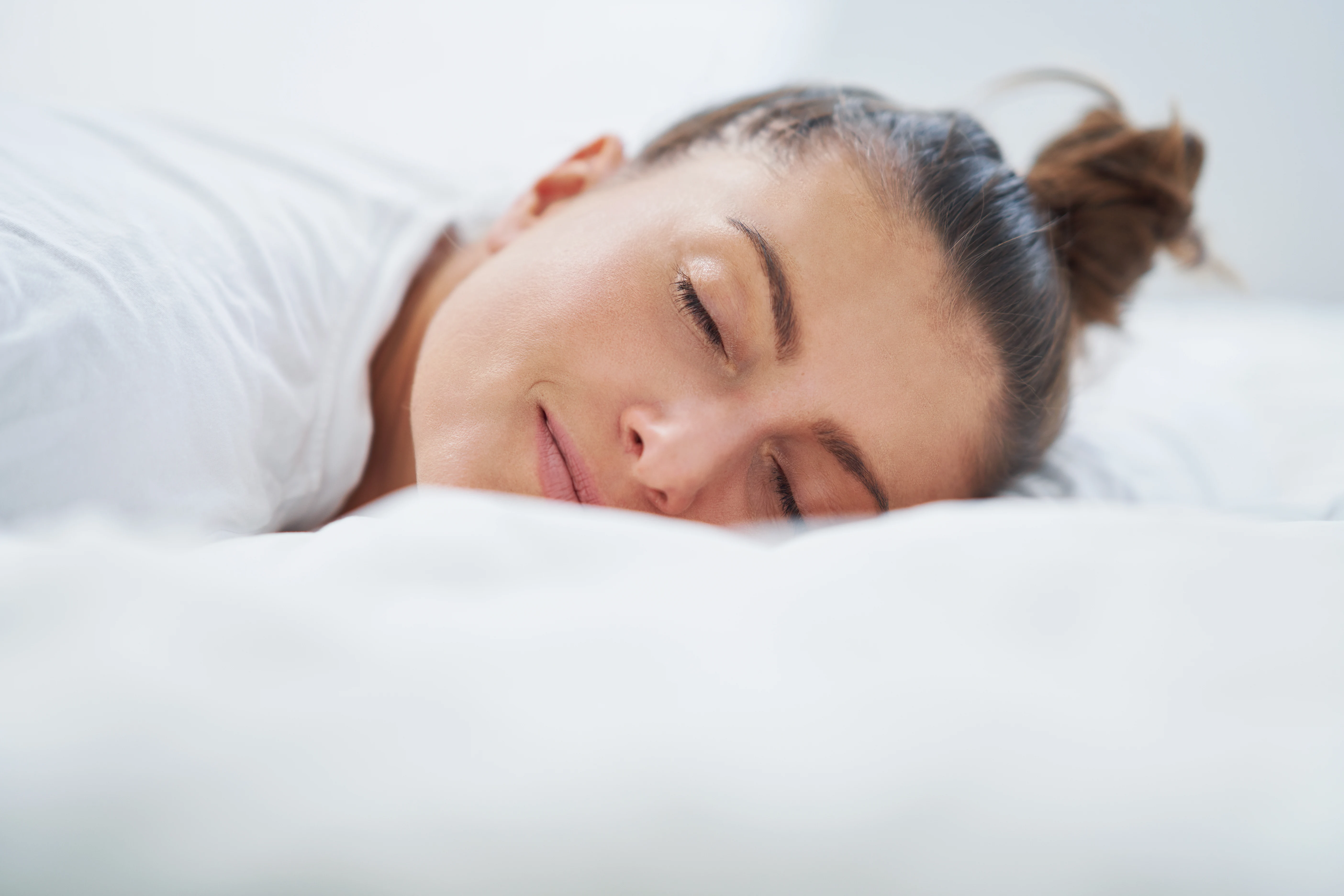 Nice female in bed relaxing or doing yoga