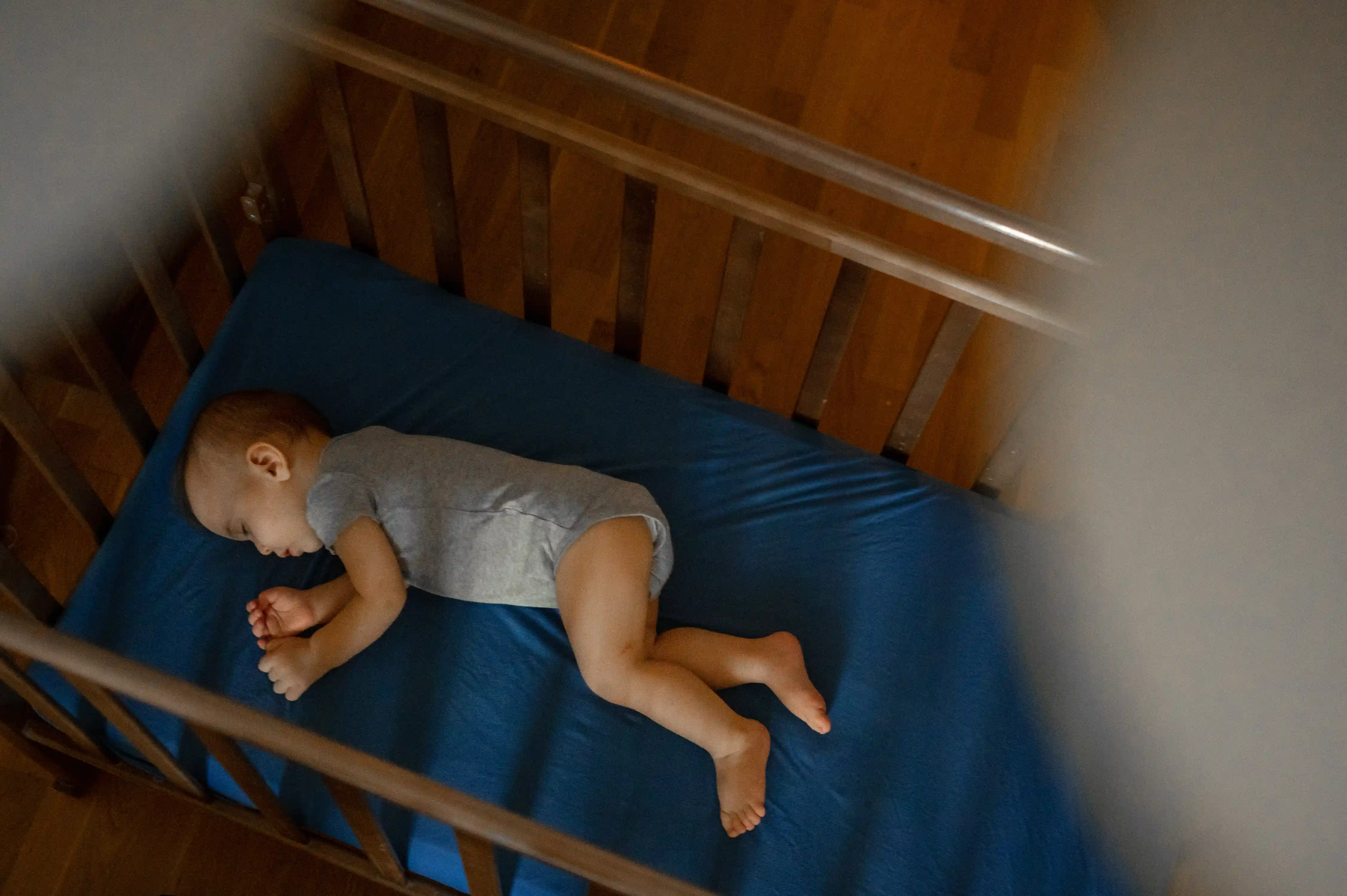 Baby Sleeping Peacefully in Crib at Home
